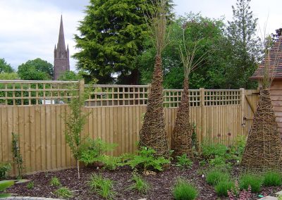 Willow sculptures reflecting the church steeple