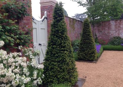 yew pyramids framing the gates